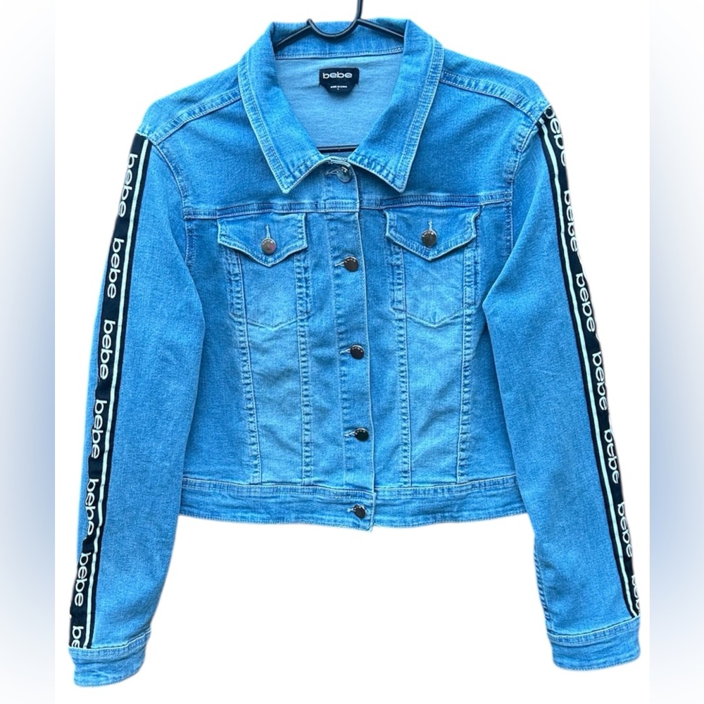 BEBE Woman’s Button Up Logo Sleeve Detail 
Light Blue Denim Jacket Size: L